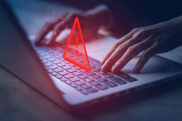 SystemHackedWarningAlertOnNotebooklaptopCyberAttackOn Scammer