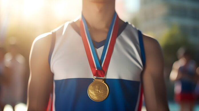 A boy wearing the gold medal on neck Close up of a gold medal around a boy neck