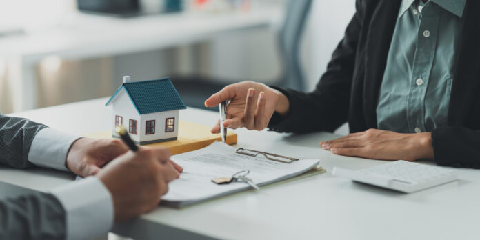 Close up Business woman or Real Estate agent explain signing agreement for buying house Bank manager and real estate concept